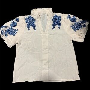 White and blue floral embroidered blouse with ruffled collar and sleeves